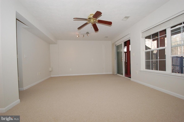 unfurnished room featuring a ceiling fan, baseboards, and carpet flooring