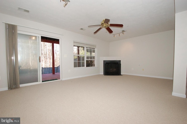 unfurnished living room with a fireplace with flush hearth, carpet flooring, and baseboards