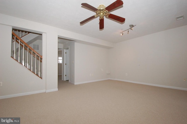 spare room with stairway, baseboards, and visible vents