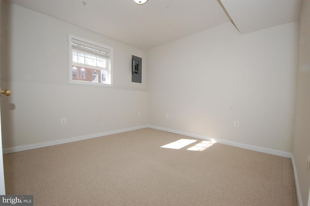 carpeted empty room with electric panel and baseboards