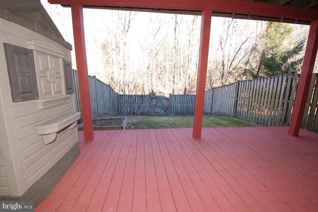 wooden terrace featuring a fenced backyard