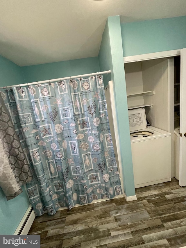 full bathroom with a shower with curtain, washer / clothes dryer, baseboard heating, and wood finished floors