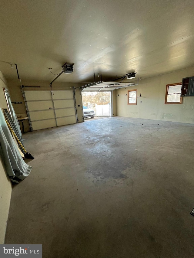 garage with electric panel and a garage door opener