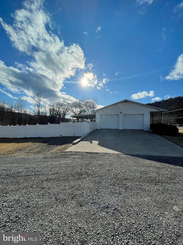 detached garage featuring fence