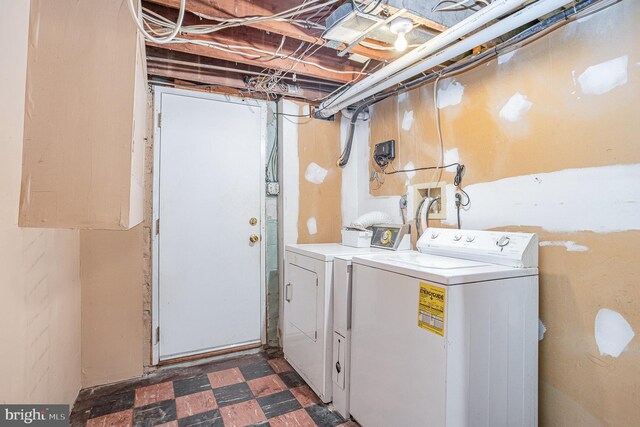 laundry room featuring laundry area, tile patterned floors, and washing machine and clothes dryer