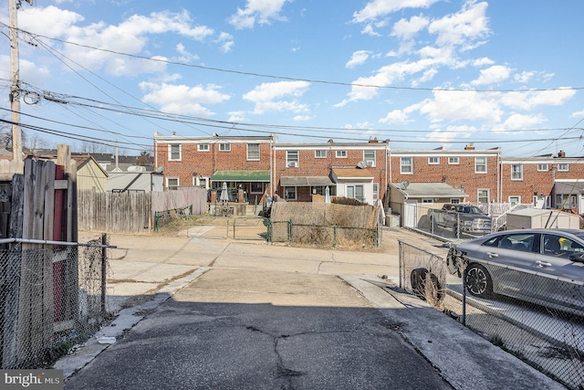 view of front of property with a fenced front yard, a residential view, and a gate