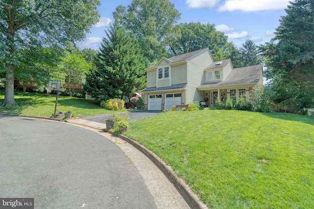 view of front facade featuring driveway, an attached garage, and a front lawn