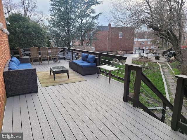 wooden terrace with outdoor dining area and an outdoor living space