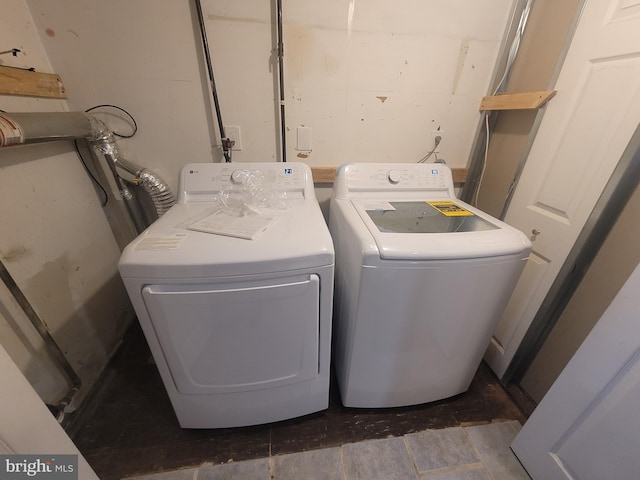 clothes washing area featuring laundry area and washer and dryer