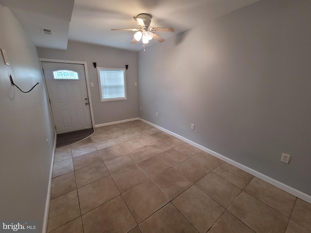 tiled foyer entrance featuring a ceiling fan, visible vents, and baseboards