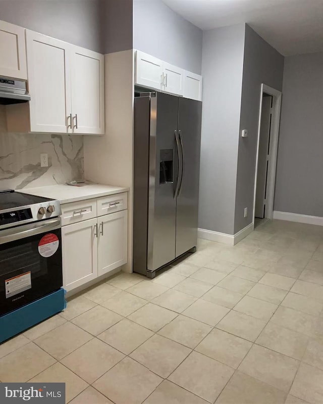 kitchen with tasteful backsplash, appliances with stainless steel finishes, light countertops, under cabinet range hood, and white cabinetry