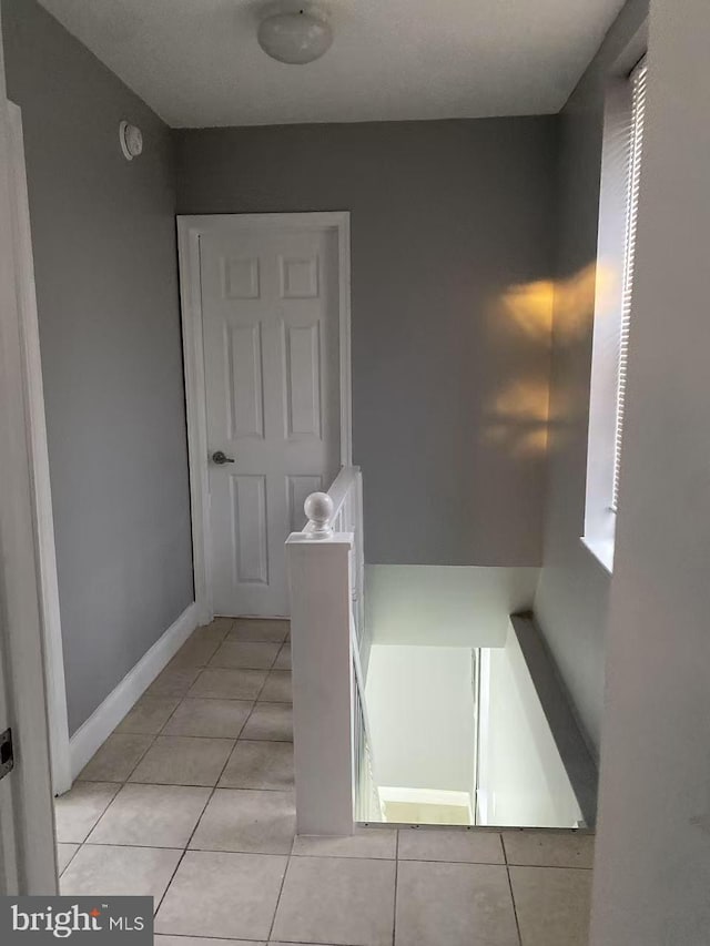 bathroom with baseboards and tile patterned floors