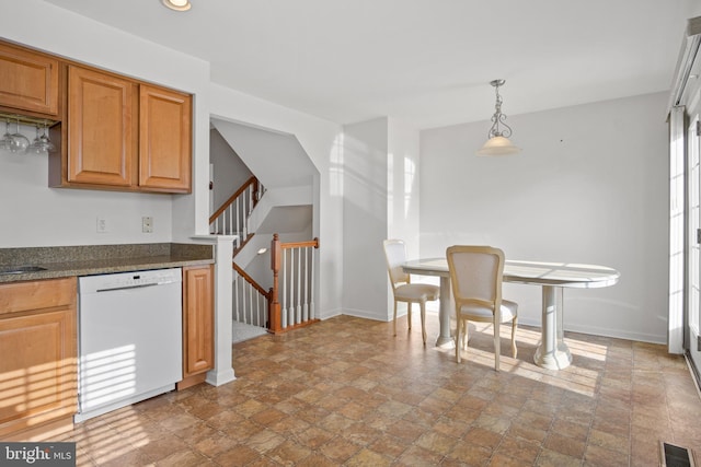 kitchen featuring stone finish flooring, visible vents, dishwasher, and baseboards