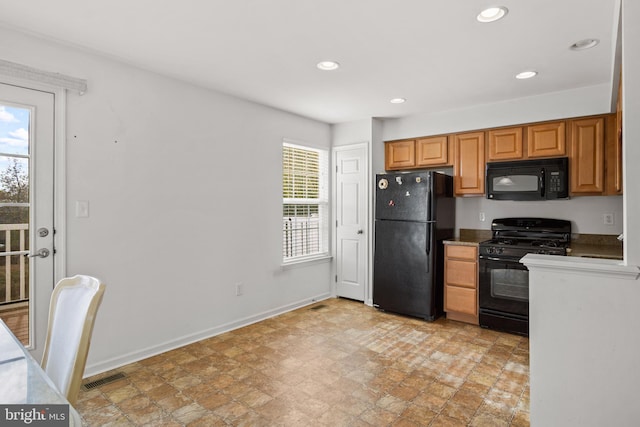 kitchen with a healthy amount of sunlight, black appliances, baseboards, and visible vents