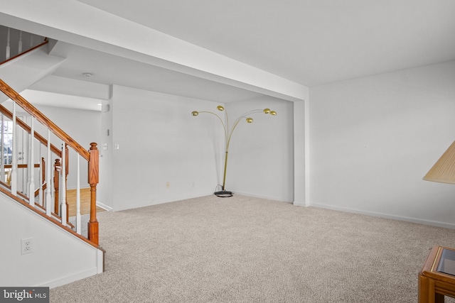 interior space featuring carpet floors, stairway, and baseboards