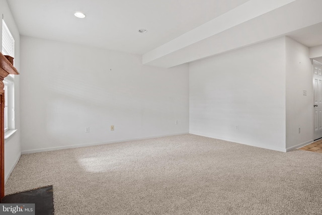 unfurnished living room with carpet floors, baseboards, and recessed lighting