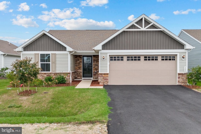 view of front of house featuring board and batten siding, stone siding, a garage, and aphalt driveway