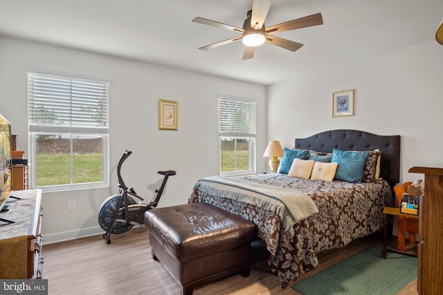 321 Windflower Dr Unit 9, Millsboro, DE 19966 - bedroom featuring multiple windows, wood finished floors, a ceiling fan, and baseboards