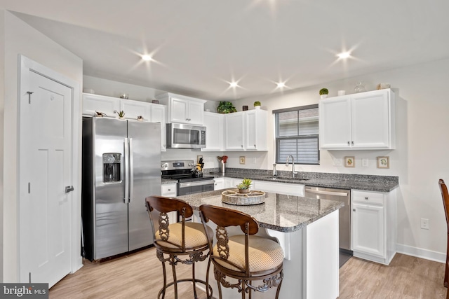 321 Windflower Dr Unit 9, Millsboro, DE 19966 - kitchen featuring light wood-style floors, white cabinetry, appliances with stainless steel finishes, and a sink