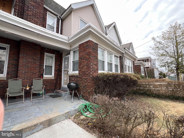 view of side of home featuring brick siding