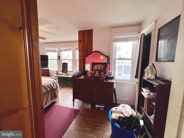 bedroom featuring radiator and wood finished floors