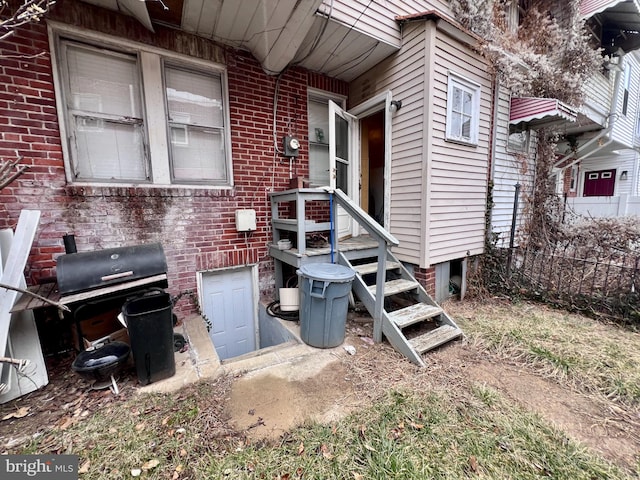 doorway to property featuring brick siding