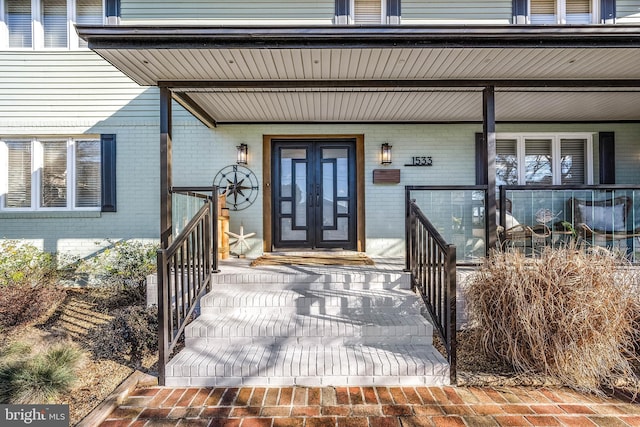 doorway to property with brick siding