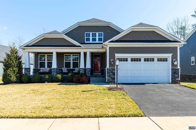 craftsman house featuring aphalt driveway, covered porch, a garage, stone siding, and a front lawn