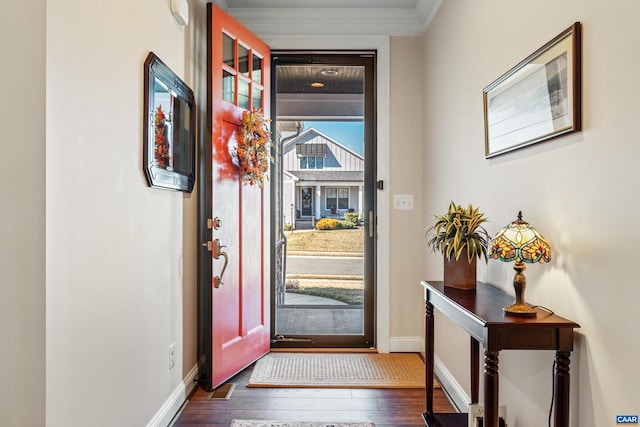 foyer with crown molding, baseboards, and hardwood / wood-style floors