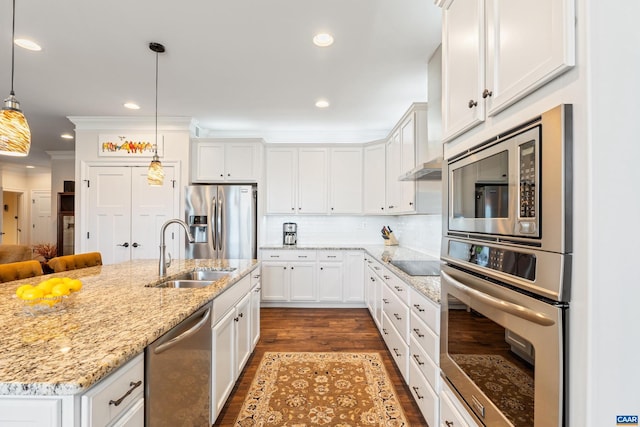 kitchen featuring stainless steel appliances, tasteful backsplash, ornamental molding, white cabinets, and a sink