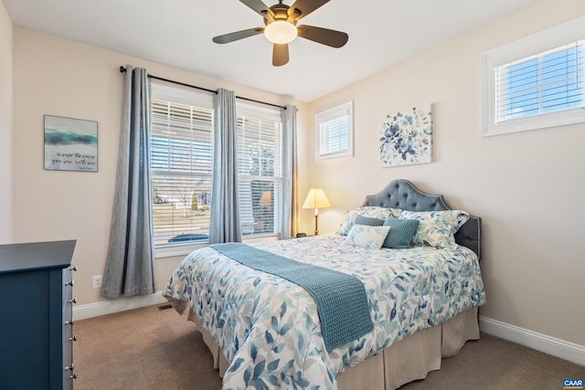 carpeted bedroom featuring ceiling fan and baseboards