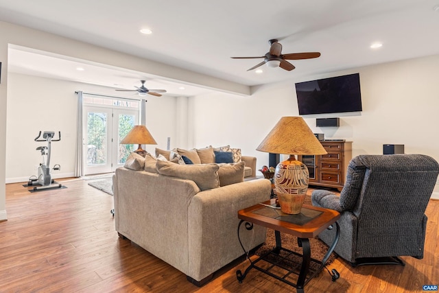 living area with recessed lighting, baseboards, and wood finished floors