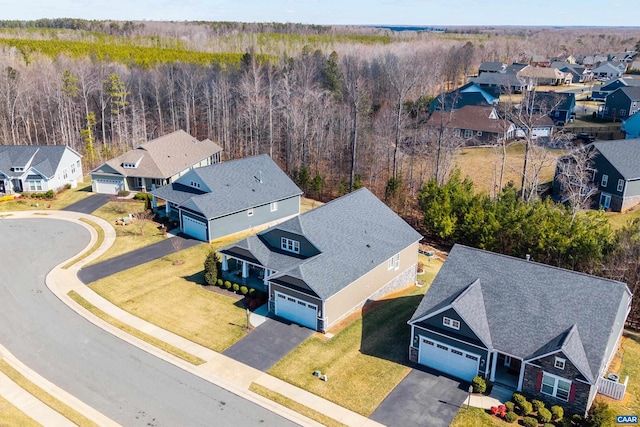 birds eye view of property with a residential view and a view of trees