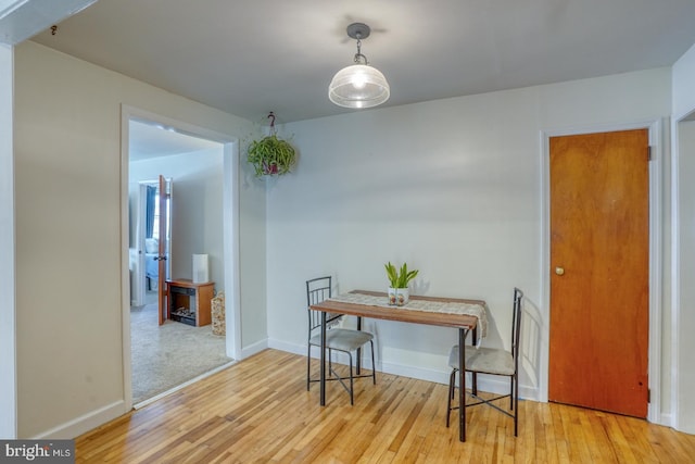 dining room with baseboards and hardwood / wood-style floors