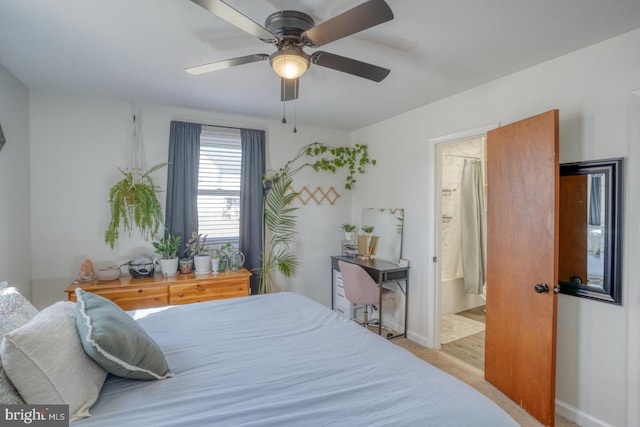 bedroom featuring a ceiling fan, carpet floors, baseboards, and ensuite bathroom