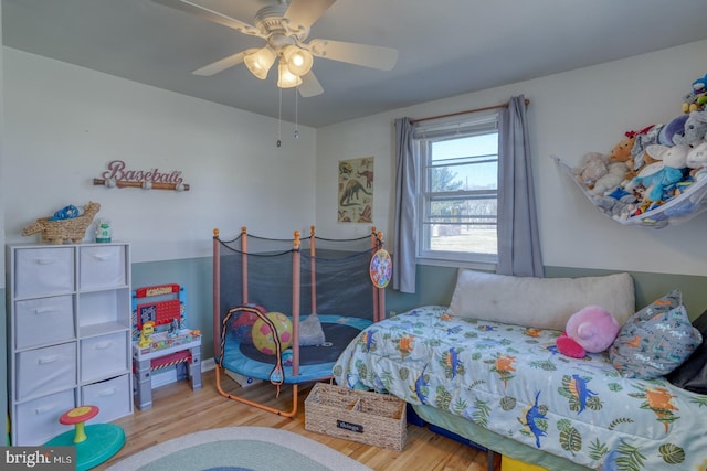 bedroom with ceiling fan and wood finished floors