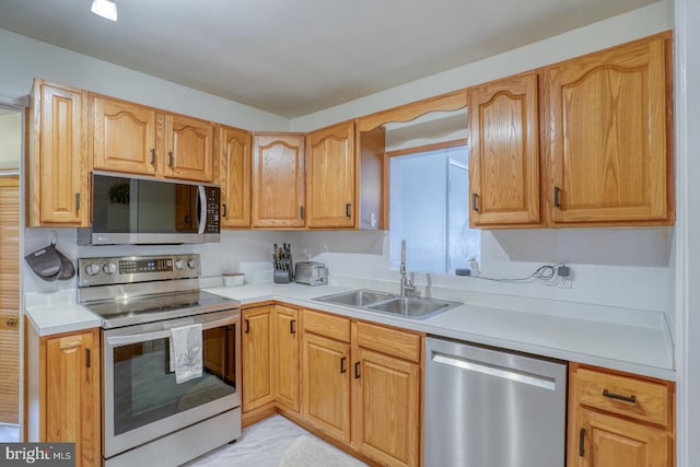 kitchen with stainless steel appliances, light countertops, and a sink