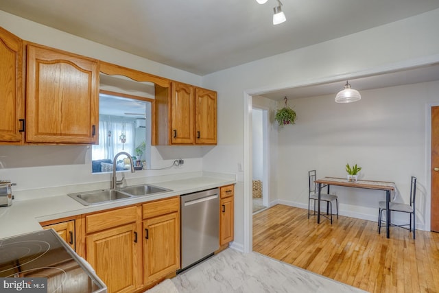 kitchen featuring a sink, baseboards, light countertops, marble finish floor, and dishwasher