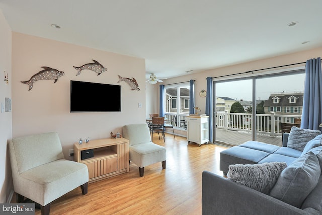 living room with light wood finished floors and ceiling fan