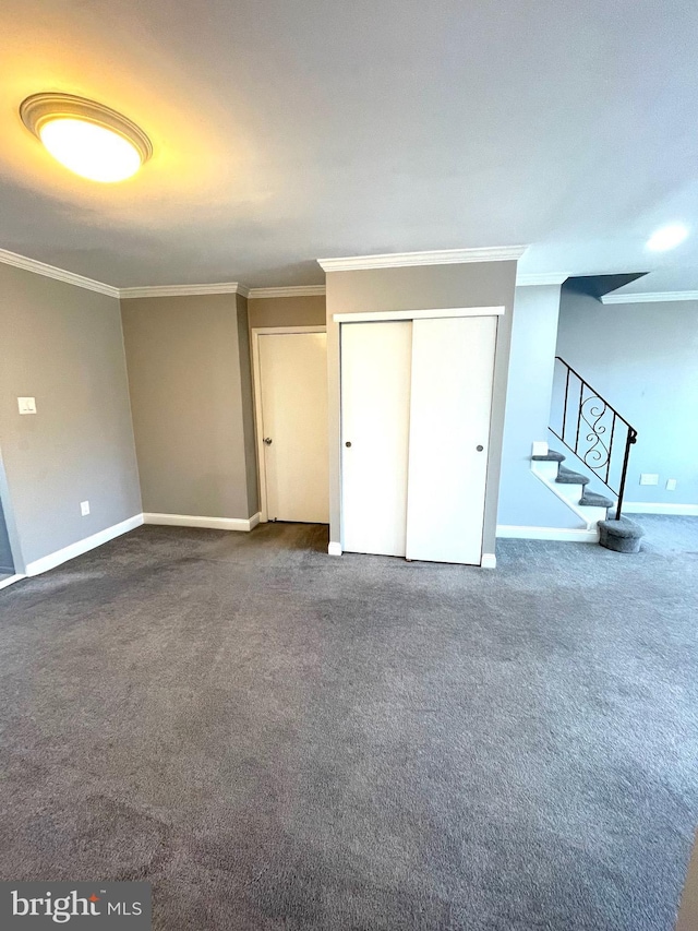 unfurnished bedroom featuring ornamental molding, a closet, carpet, and baseboards