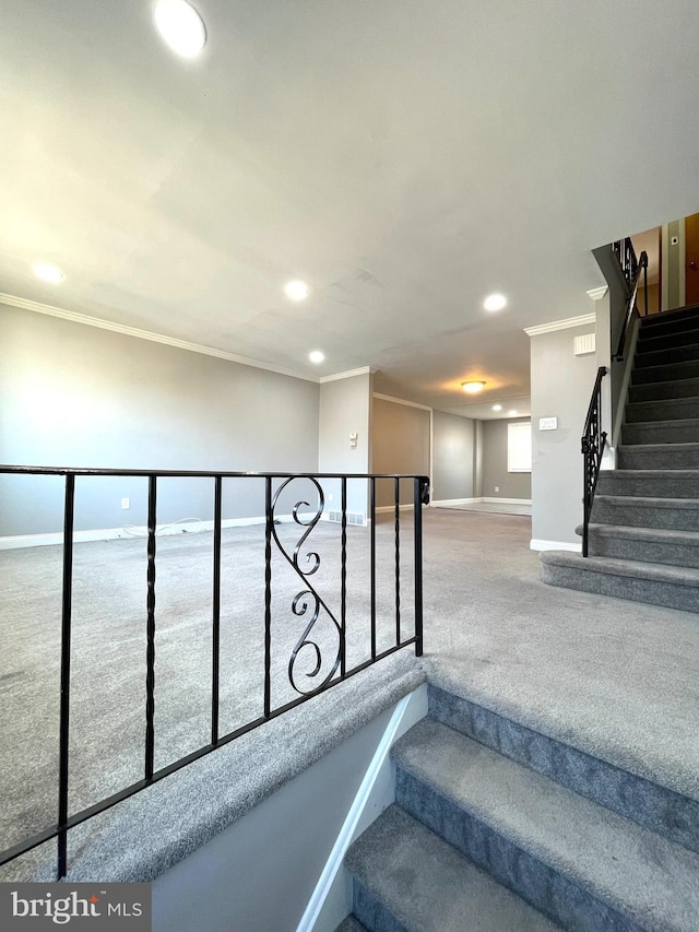 stairs with carpet, ornamental molding, baseboards, and recessed lighting