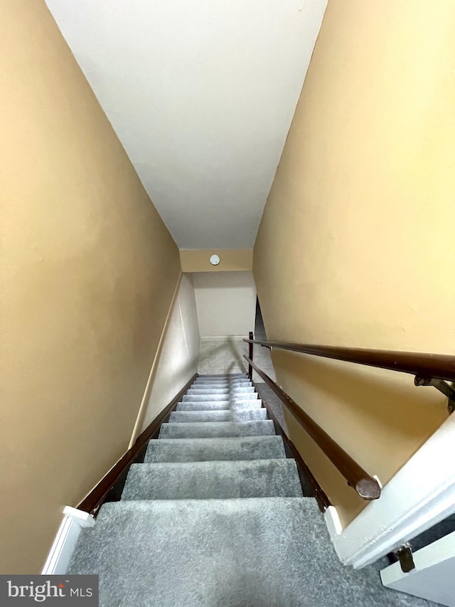 staircase featuring baseboards