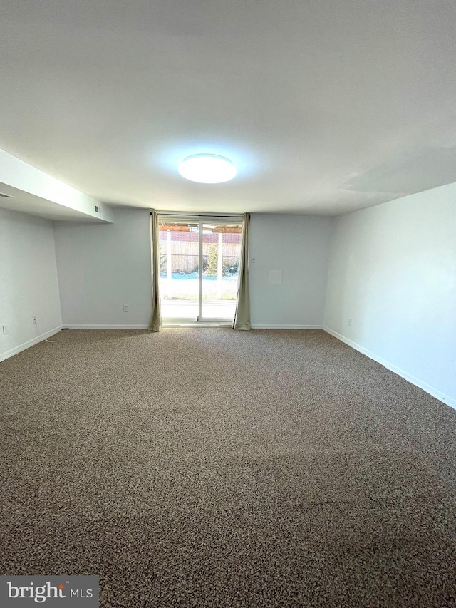 empty room with carpet floors and baseboards