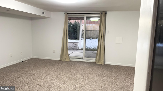 carpeted spare room featuring visible vents and baseboards