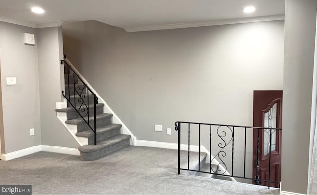 stairway featuring carpet, baseboards, and crown molding