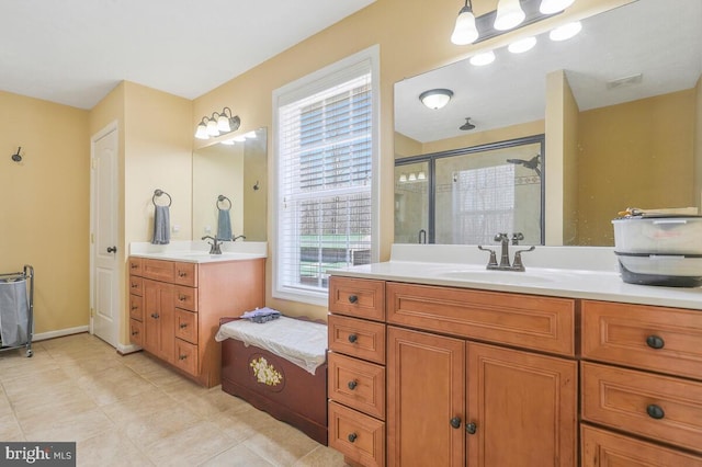 bathroom featuring tile patterned flooring, two vanities, a sink, visible vents, and a stall shower