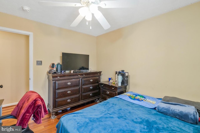 bedroom with ceiling fan and wood finished floors