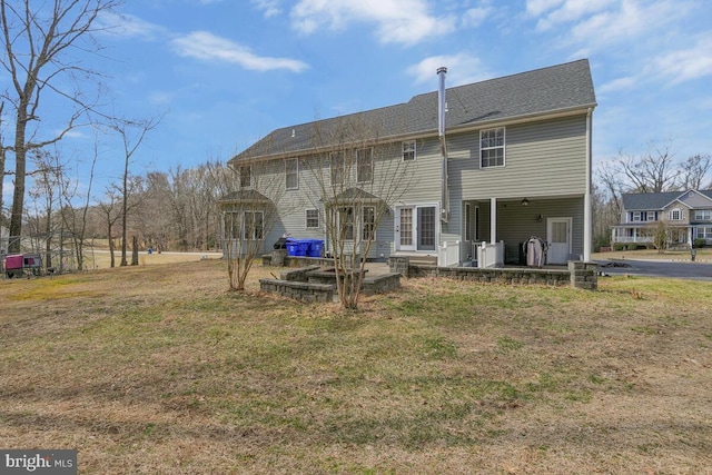 rear view of property with a lawn and a patio area