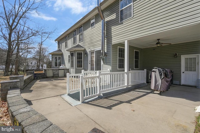 back of property with ceiling fan, a patio, and area for grilling