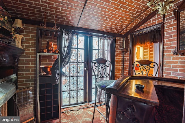 interior space with lofted ceiling, brick ceiling, brick wall, and french doors